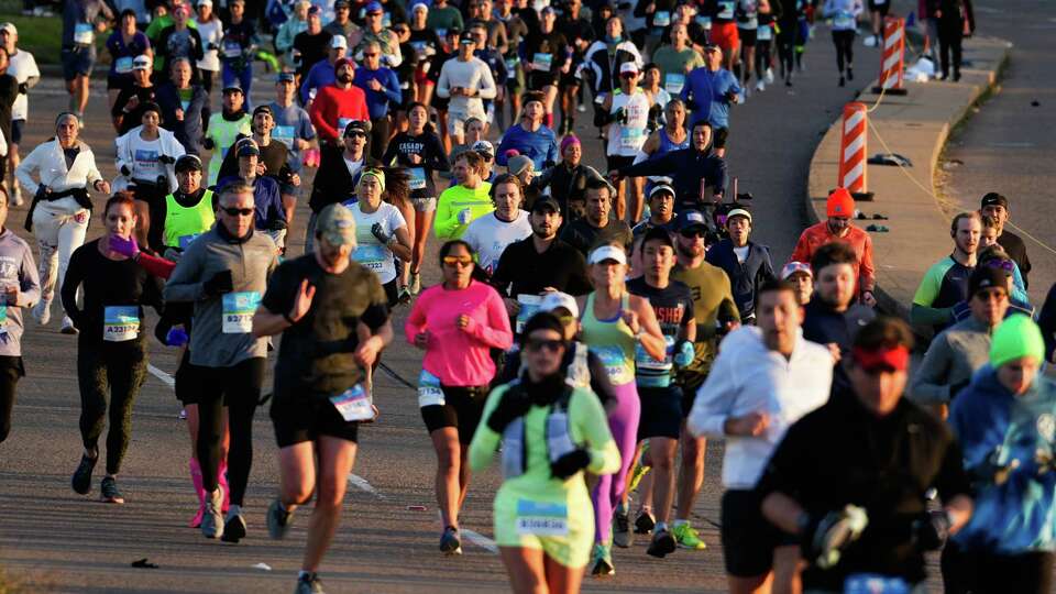 Runners make their way along Waugh Drive during the Chevron Houston Marathon, Sunday, Jan. 14, 2024, in Houston.