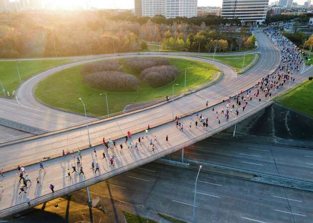 Runners make their way down Waught Avenue during the Chevron Houston Marathon, Sunday, Jan. 14, 2024, in Houston.