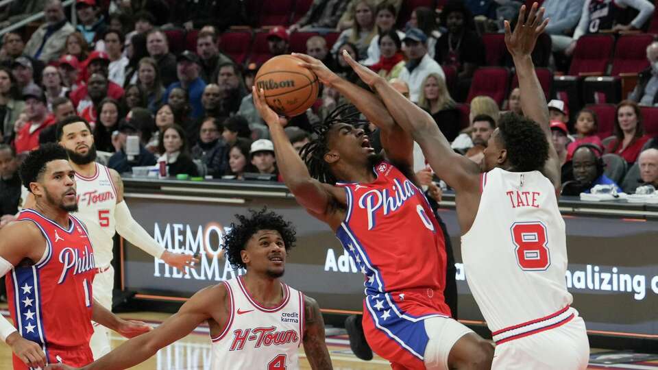 Philadelphia 76ers guard Tyrese Maxey (0) is fouled by Houston Rockets forward Jae'Sean Tate (8) during an NBA basketball game at Toyota Center, Friday, Dec. 29, 2023, in Houston.