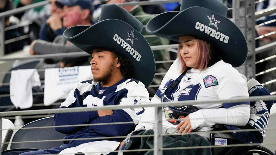 Dallas Cowboys supporters look on during the second half of an NFL football game against the Green Bay Packers, Sunday, Jan. 14, 2024, in Arlington, Texas. (AP Photo/Sam Hodde)