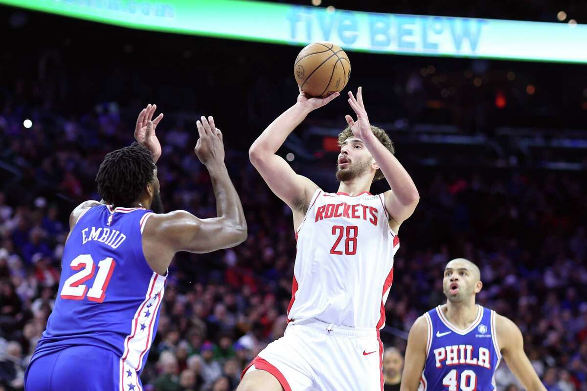 PHILADELPHIA, PENNSYLVANIA - JANUARY 15: Alperen Sengun #28 of the Houston Rockets shoots over Joel Embiid #21 of the Philadelphia 76ers during the second quarter at the Wells Fargo Center on January 15, 2024 in Philadelphia, Pennsylvania. NOTE TO USER: User expressly acknowledges and agrees that, by downloading and or using this photograph, User is consenting to the terms and conditions of the Getty Images License Agreement.