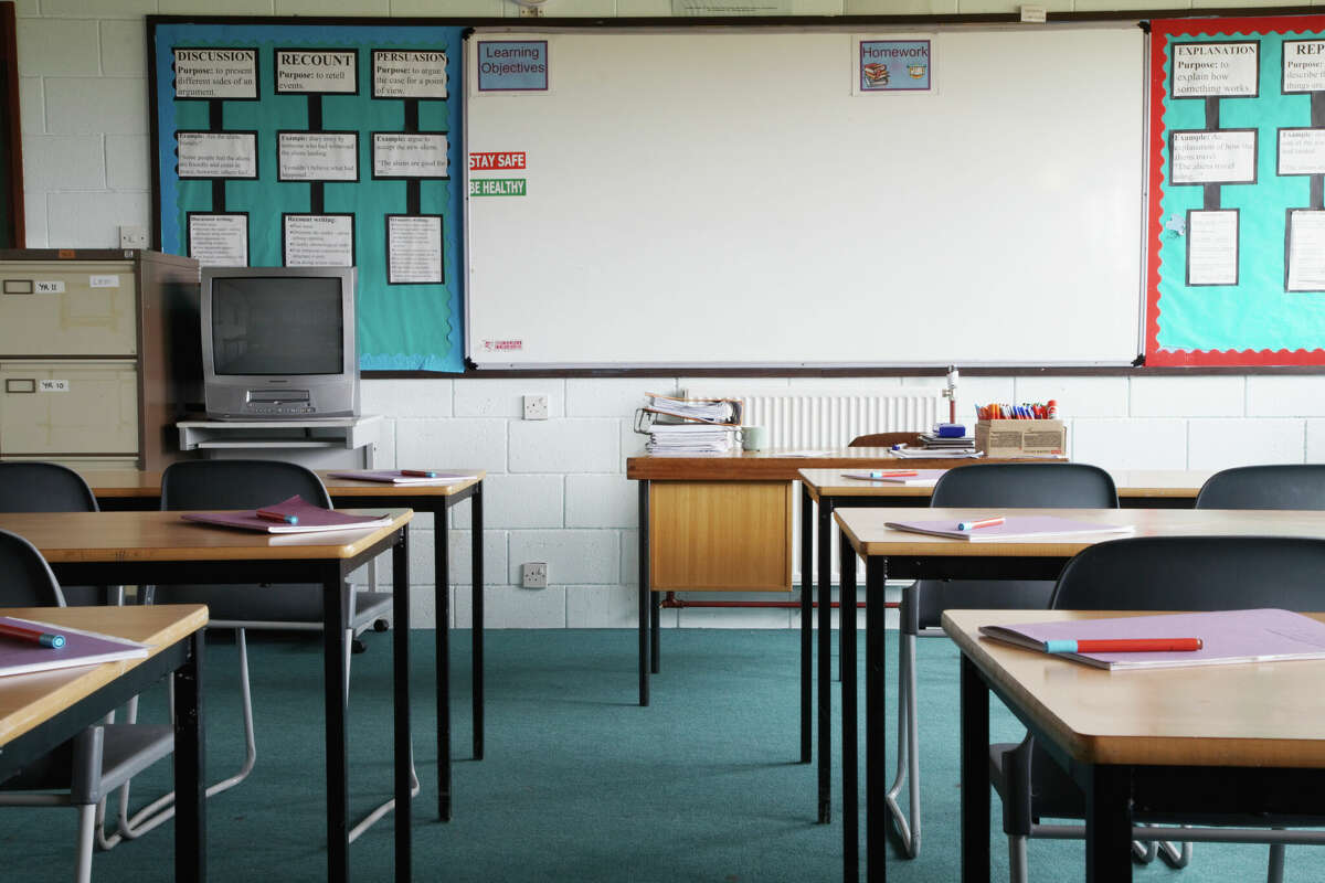 Stock photo: Empty school classroom, exercise books and pens on table.