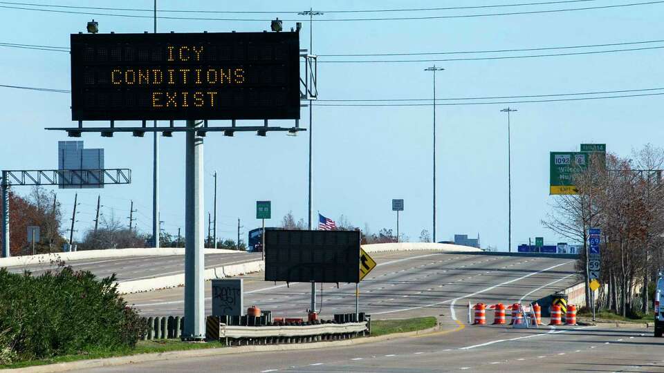 A sign warns of icy road conditions and the northbound entrance ramp is blocked as IH-69 northbound is closed between SH-99 Lanier Pkwy/FM 2759 to US-90 in Stafford, Tuesday, Jan. 16, 2024.