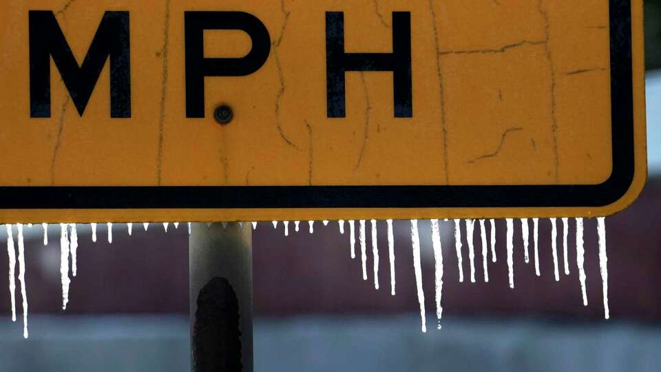 Icicles are shown dripping from a road sign along SH 249 Hwy. near FM 1960 Rd. Tuesday, Jan. 16, 2024, in Houston.