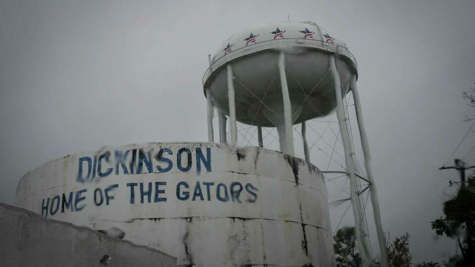 Rain falling on a windshield obscures the view of a water tower Thursday, Nov. 30, 2023, in Dickinson.