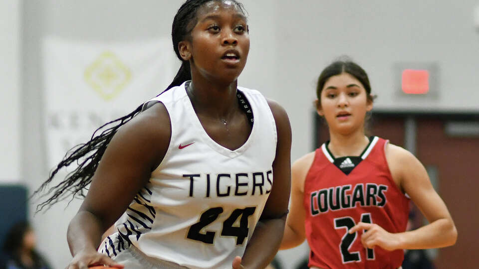 Klein Collins junior small forward Christin Callens (24) dribbles the ball up court in front of Tomball junior small forward Megan Zullo (21) during the first quarter of their District 15-6A matchup at Klein Collins High School on Wednesday, Jan. 11, 2023.