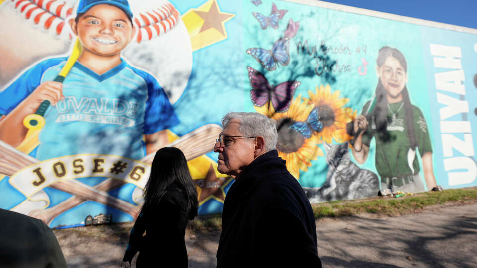 Attorney General Merrick Garland, right, and Associate Attorney General Vanita Gupta, left, tour murals of shooting victims, Wednesday, Jan. 17, 2024, in Uvalde, Texas. The Justice Department is planning this week to release findings of an investigation into the 2022 school shooting. (AP Photo/Eric Gay)