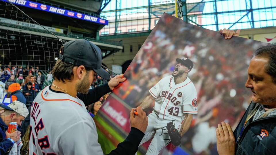 Astros Pitcher Lance McCullers Jr. signs a poster and other items for fans during Astros FanFest on Saturday, Jan. 20, 2024, at Minute Maid Park in Houston.