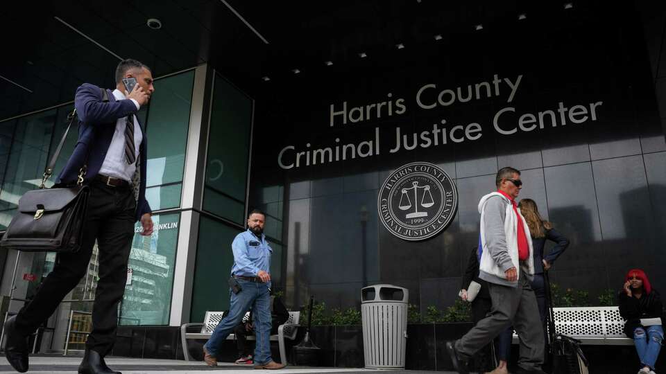 People walk in front of the Harris County Criminal Courthouse on Thursday, Jan. 25, 2024, in Houston.
