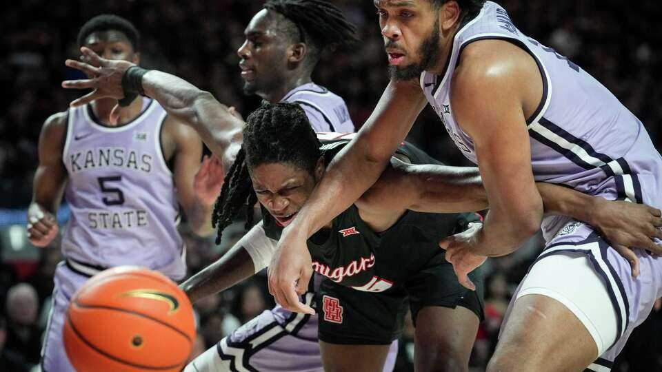 Houston Cougars forward Joseph Tugler (25) fights with Kansas State Wildcats forward Will McNair Jr. (13) for a rebound during the first half of a NCAA basketball game Saturday, Jan. 27, 2024, at the Fertitta Center at the University of Houston in Houston.