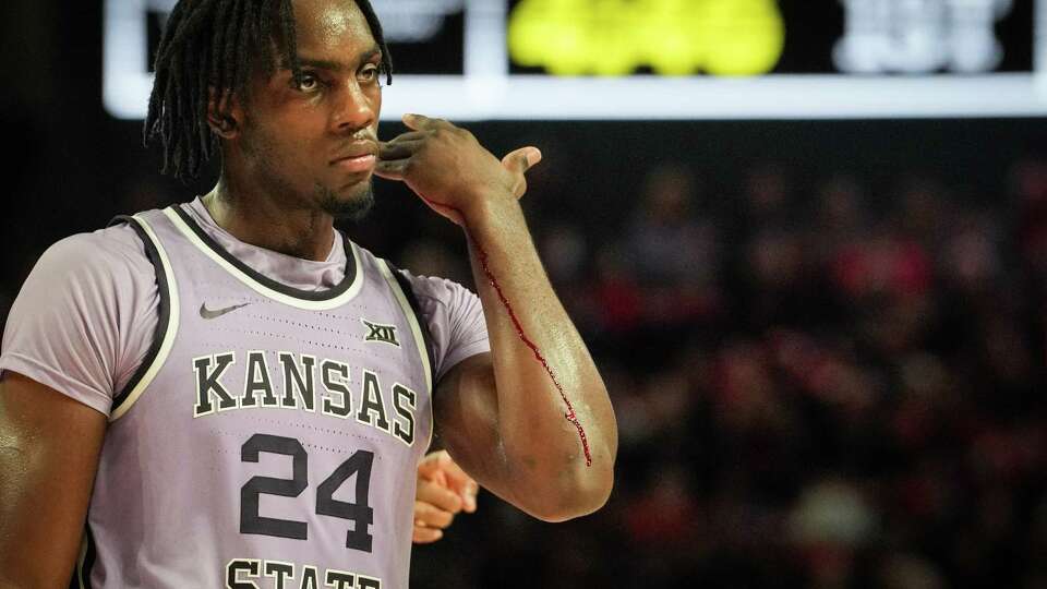 Kansas State Wildcats forward Arthur Kaluma (24) walks to the bench for a bandage during the first half of a NCAA basketball game Saturday, Jan. 27, 2024, at the Fertitta Center at the University of Houston in Houston.