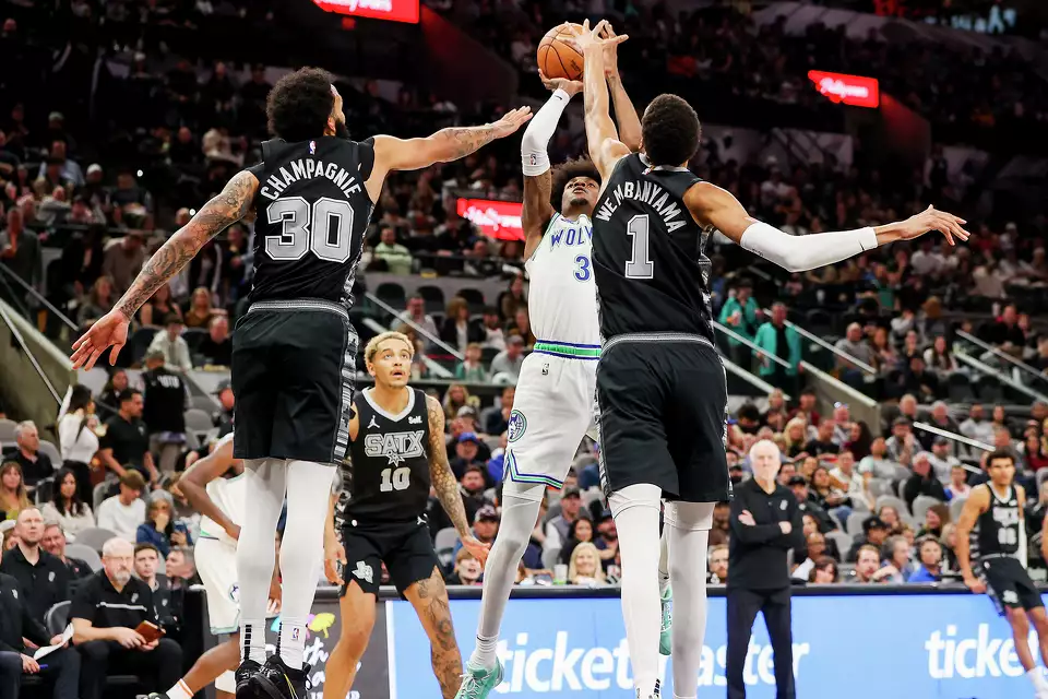 San Antonio Spurs forward Julian Champagnie (30) and forward Victor Wembanyama (1) try to block a shot by Minnesota Timberwolves forward Jaden McDaniels during the second half of their NBA game at the Frost Bank Center on Saturday, Jan. 27, 2024. San Antonio held on to beat Minnesota 113-112.