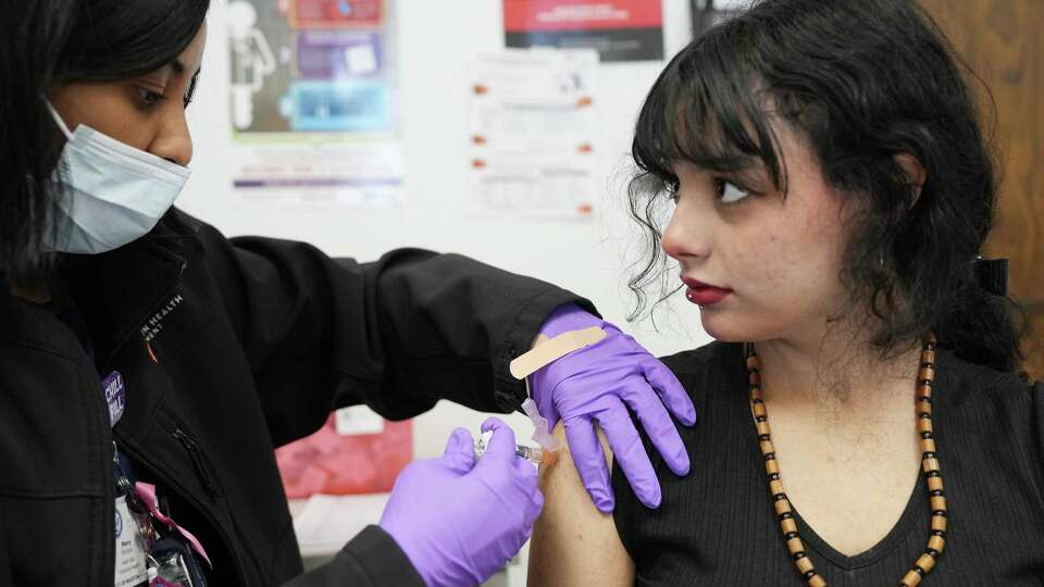 Sharpstown Health Services nurse Monique Perry, LVN, administers a vaccine to Kamilah Chacin, 14, on Thursday, Feb. 1, 2024 in Houston. Non-medical vaccine exemptions for Texas schoolkids hit a 10-year high last year, with 3.24 percent of all kindergarteners requesting an exemption for one or more required immunization.