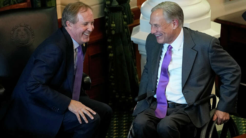 Texas Attorney General Ken Paxton, left, and Gov. Greg Abbott, right, talk during a swearing in ceremony on the first day of the 88th Texas Legislative Session in Austin, Texas, Tuesday, Jan. 10, 2023. (AP Photo/Eric Gay)