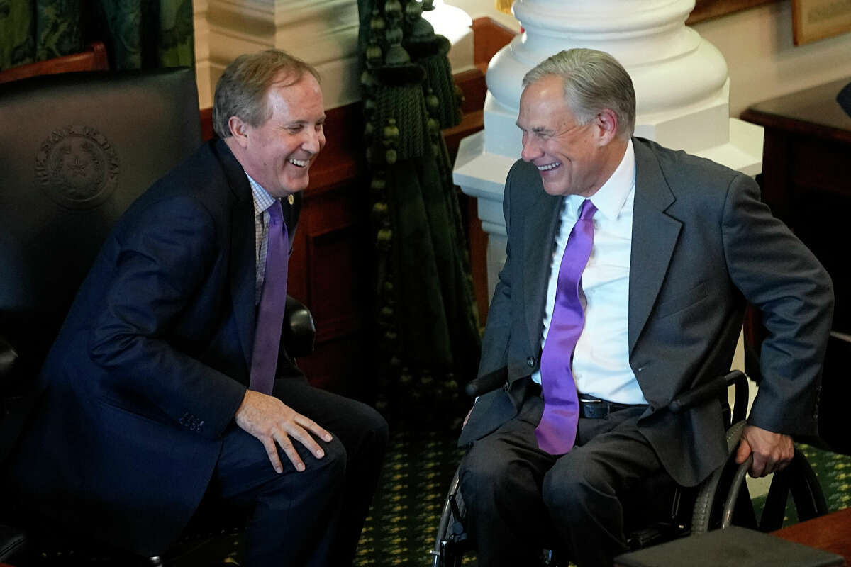 Texas Attorney General Ken Paxton, left, and Gov. Greg Abbott, right, talk during a swearing in ceremony on the first day of the 88th Texas Legislative Session in Austin, Texas, Tuesday, Jan. 10, 2023. (AP Photo/Eric Gay)