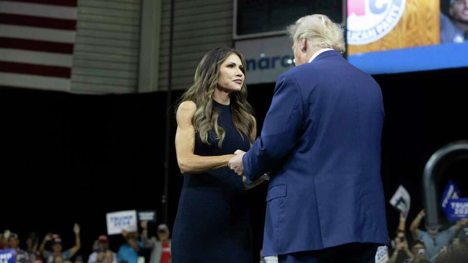 FILE - Former President Donald Trump greets South Dakota Gov. Kristi Noem at the South Dakota Republican Party Monumental Leaders rally Friday, Sept. 8, 2023, in Rapid City, S.D. A South Dakota tribe has banned Noem from the Pine Ridge Reservation after she spoke this week about wanting to send razor wire and security personnel to Texas to help deter immigration at the U.S.-Mexico border and also said cartels are infiltrating the state's reservations.