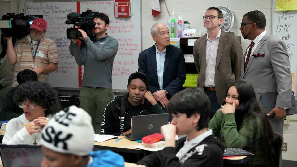 Houston ISD Superintendent Mike Miles, left, Texas Education Commissioner Mike Morath, and Brandon Dickerson, principal, right, visit in a classroom at Kashmere High School, 6900 Wileyvale Rd., Tuesday, Feb. 6, 2024, in Houston.