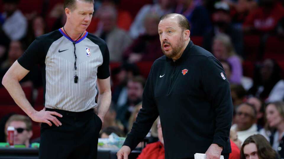 Referee Ed Malloy, left, listens as New York Knicks head coach Tom Thibodeau argues a foul call during the second half of an NBA basketball game against the Houston Rockets Monday, Feb. 12, 2024, in Houston. (AP Photo/Michael Wyke)