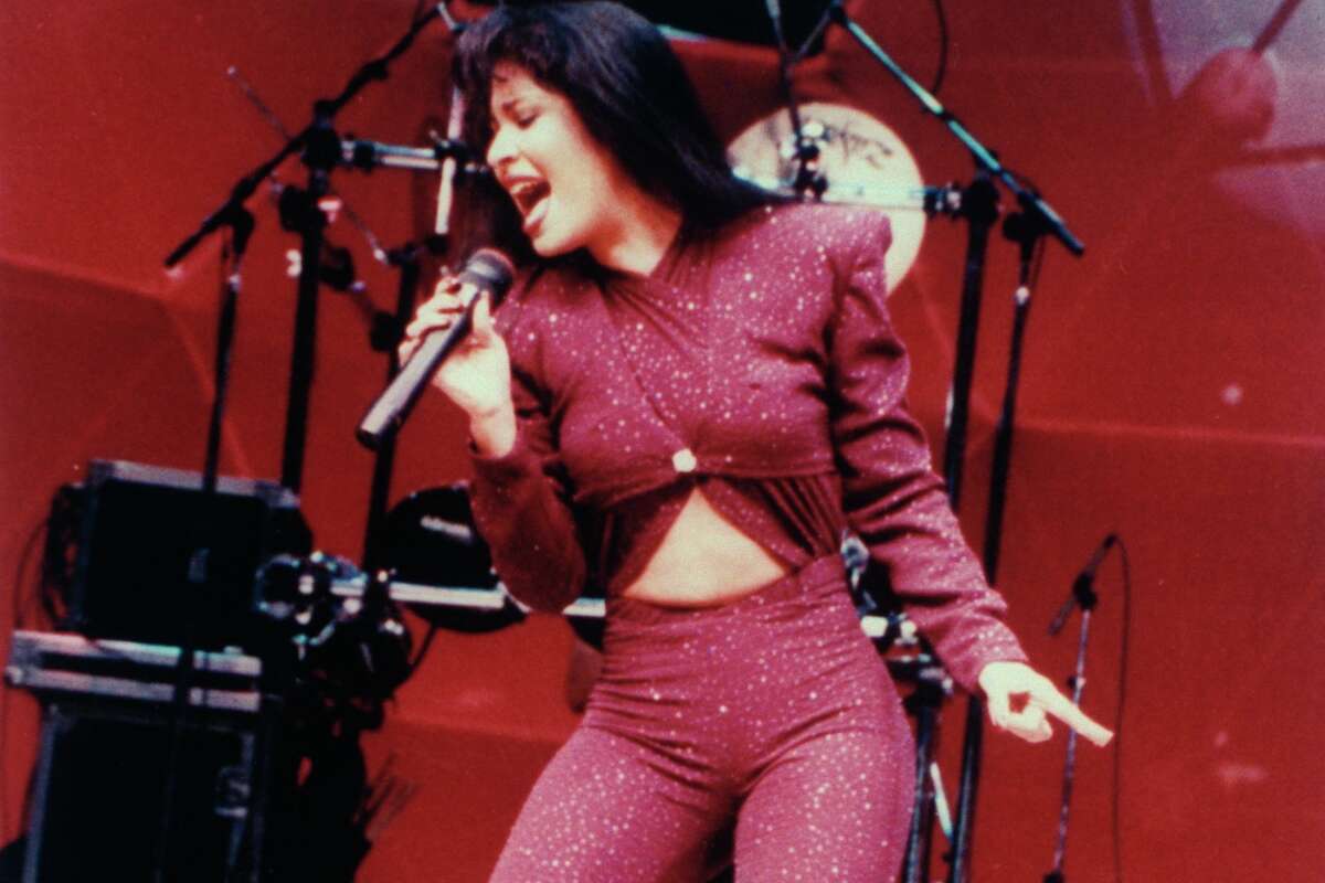 Mexican singer Selena performing in concert; one month later she would be shot and killed by Yolanda Saldivar, the pres. of her fan club, after confronting her on charges that she was embezzling funds.