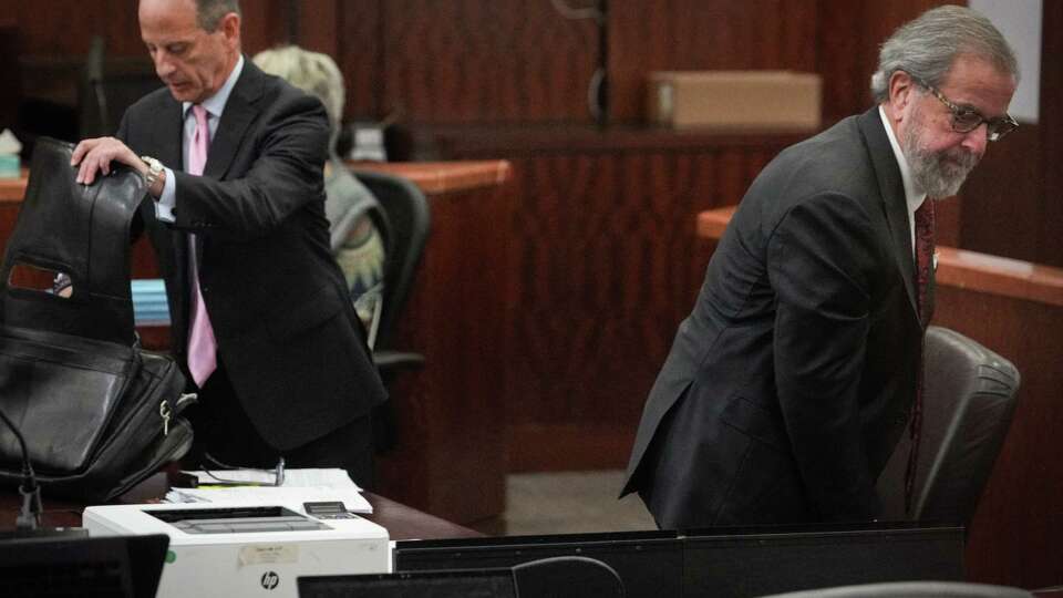 Prosecutors pro tem Kent Schaffer, right, and Brian Wice pack up after a hearing in the securities fraud case of Texas Attorney General Ken Paxton on Friday, Feb. 16, 2024, in the 185th District Court at the Harris County criminal courthouse in Houston. Schaffer withdrew from the case.