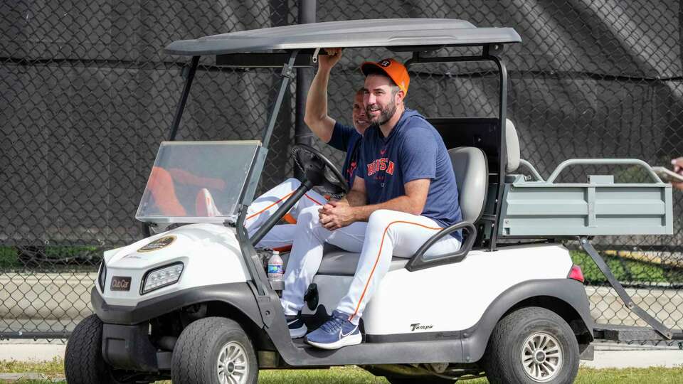 Houston Astros pitcher Justin Verlander (35) sits in a cart with manager Joe Espada (19) as they watched Josh Hader pitch during workouts for Houston Astros pitchers and catchers at CACTI Park of the Palm Beaches on Friday, Feb. 16, 2024, in West Palm Beach, Fl.