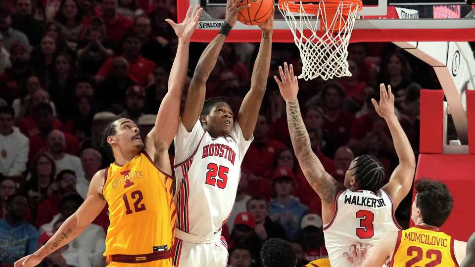 Houston forward Joseph Tugler (25) pulls down a rebound against Iowa State forward Robert Jones (12) during the first half of an NCAA college basketball game on Monday, Feb. 19, 2024, in Houston.