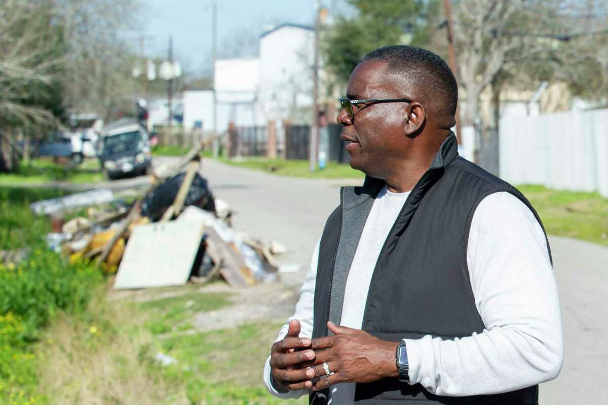 A pile of illegally dumped items is visible in the background as Melvin Hopkins, District K Constituent Services Director - Field Operations, walks back to his truck after evaluating a site with a long history of illegal dumping near S. Post Oak Boulevard Tuesday, Feb. 20, 2024.