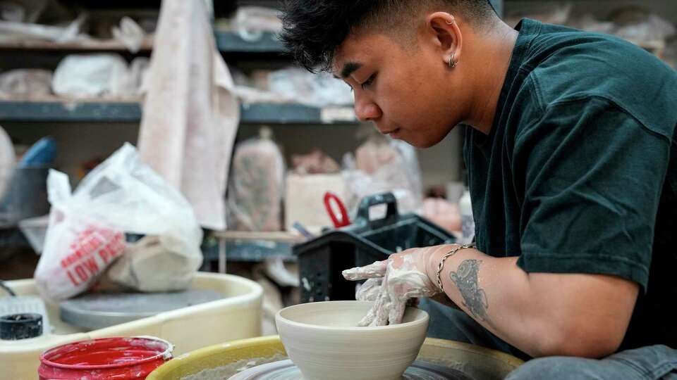 Jio Dingayan, chef de cuisine at Moneycat, throws clay as he makes a bowl at Potters Place on Wednesday, Feb. 21, 2024 in Stafford. Dingayan has joined a of chefs giving ceramics and pottery a spin, an activity that's been especially popular with foodies since the pandemic. For some chefs, it's also a way for them to put a personal stamp on their restaurants.