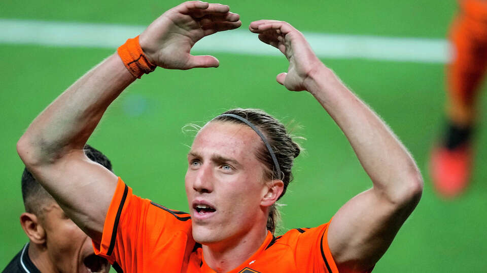 Houston Dynamo midfielder Griffin Dorsey (25) raises his arms getting the fans to cheer during the second half of an MLS Western Conference semifinal soccer match against Sporting Kansas City on Sunday, Nov. 26, 2023 in Houston. The Dynamo advanced to the MLS Western Conference Finals with a 1-0 win.