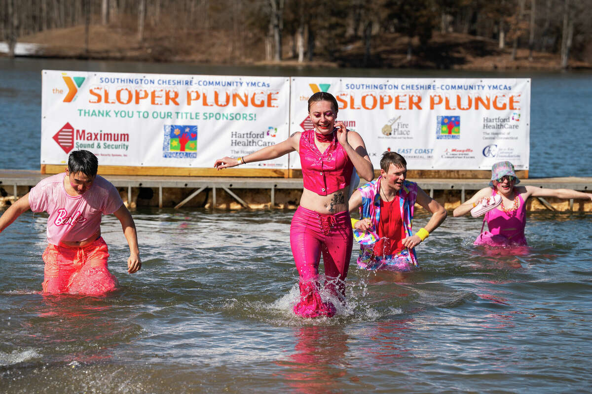 Team Lake Compounce jumps into Sloper Pond in Barbie attire for the annual Sloper Plunge hosted by the Southington-Cheshire Community YMCA on Saturday, Feb. 24, 2024 at YMCA Camp Sloper in Southington. The 19th annual plunge continues a fundraising tradition bringing together community leaders and volunteers in support of YMCA camp scholarships. 