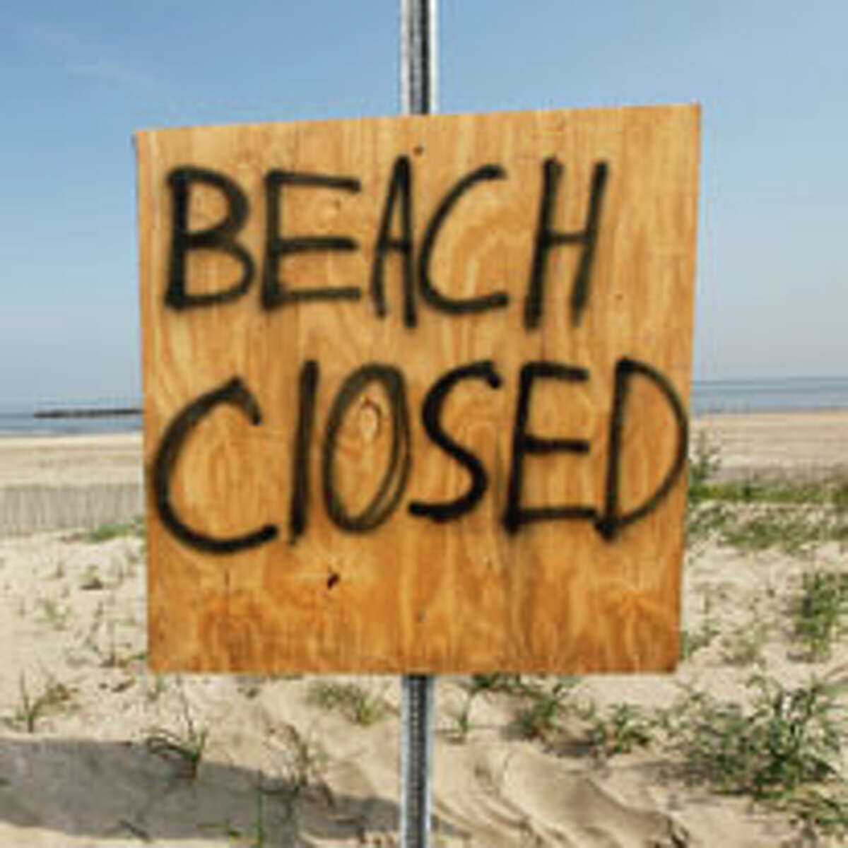 A sign marks the closed beach due to the Deepwater Horizon oil spill on Elmer's Island in in Grand Isle, La. Tuesday, May 25, 2010. (AP Photo/Gerald Herbert)