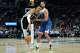 San Antonio Spurs center Victor Wembanyama, left, works toward the basket as Minnesota Timberwolves forward Kyle Anderson defends during the first half of an NBA basketball game Tuesday, Feb. 27, 2024, in Minneapolis. (AP Photo/Abbie Parr)