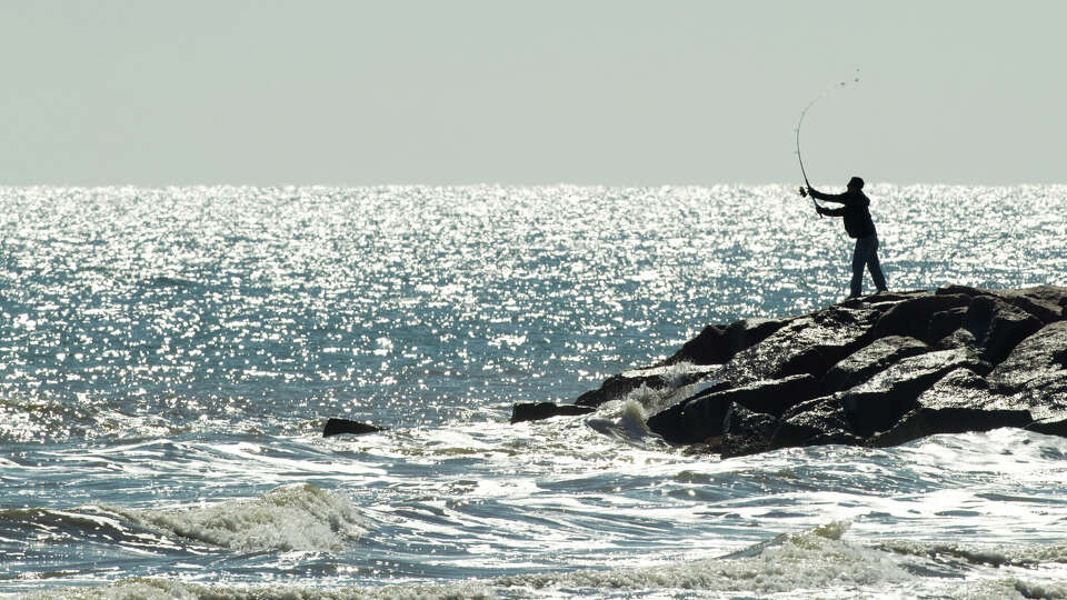 A fisherman casts his line into the Gulf of Mexico Wednesday, Nov. 28, 2012, in Galveston. Commercial fishermen scored a partial win in their challenge of federal catch limits of Gulf of Mexico red grouper.