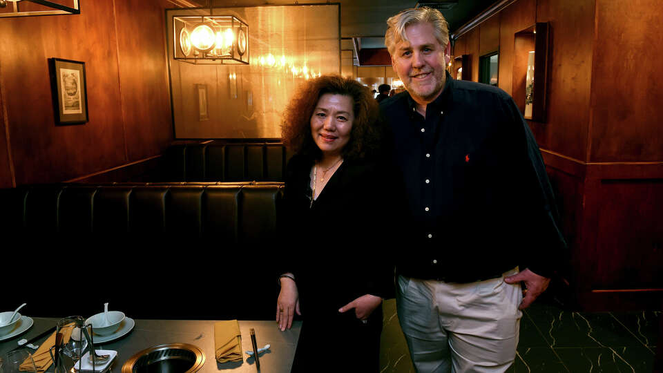 Jin Fu Hot Pot co-owners Hu Ping, left, and her husband, Jonathan Dolph, are photographed in their new restaurant on Whitney Avenue in New Haven on March 7, 2024.