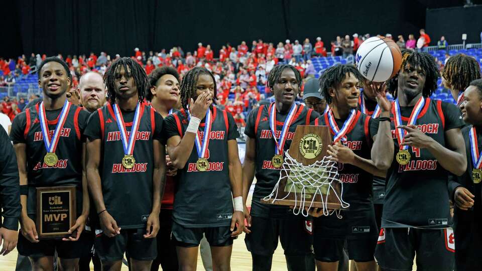 Hitchock Buldogs Bryce Dorsey (4) twirls the ball as the team poses for a photograph. Hitchcock defeated Ponder 53-49 in the 3A Championship on Saturday, March 9, 2024 at the Alamodome.