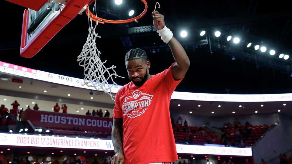 Houston guard Jamal Shead cuts down the net after their win against Kansas to be the Big 12 Champions after their Big 12 baskeball game held at the Fertitta Center Saturday, Mar. 9, 2024 in Houston.