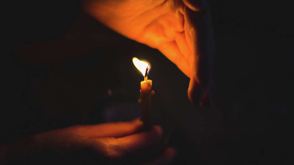 A candle burning in the dark. 