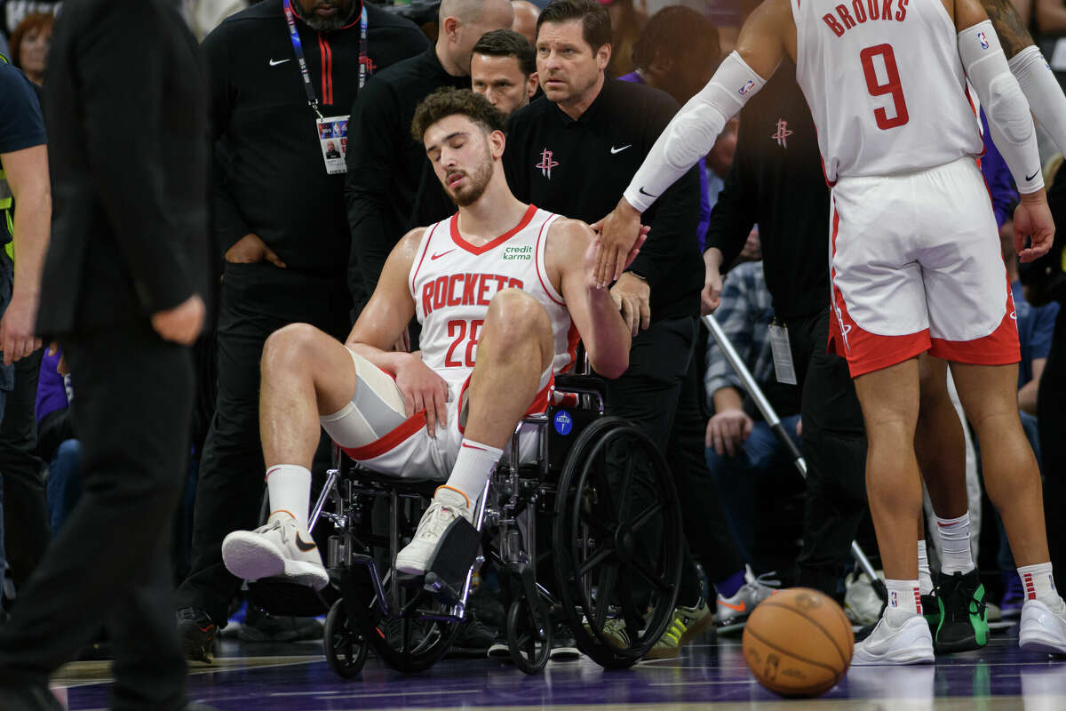 Houston Rockets center Alperen Sengun is wheeled from the arena in a wheel chair during the second half of an NBA basketball game against the Sacramento Kings in Sacramento, Calif., Sunday, March 10, 2024. 