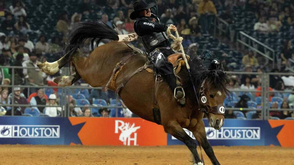 Sage Newman rides Two Cookie while competing in saddle bronc riding during the Super Series V, Round 3 of the Rodeo Houston at the Houston Livestock Show and Rodeo at NRG Park, Tuesday, March 12, 2024, in Houston.