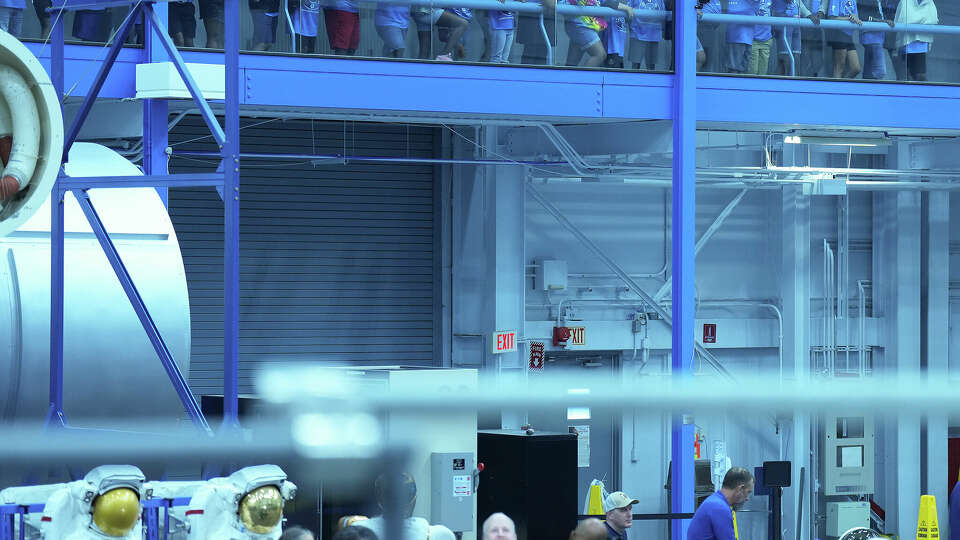 Students on tour peak into the Space Vhicle Mockup. Facility at the Johnson Space Center on Friday, Aug. 5, 2022 in Houston.