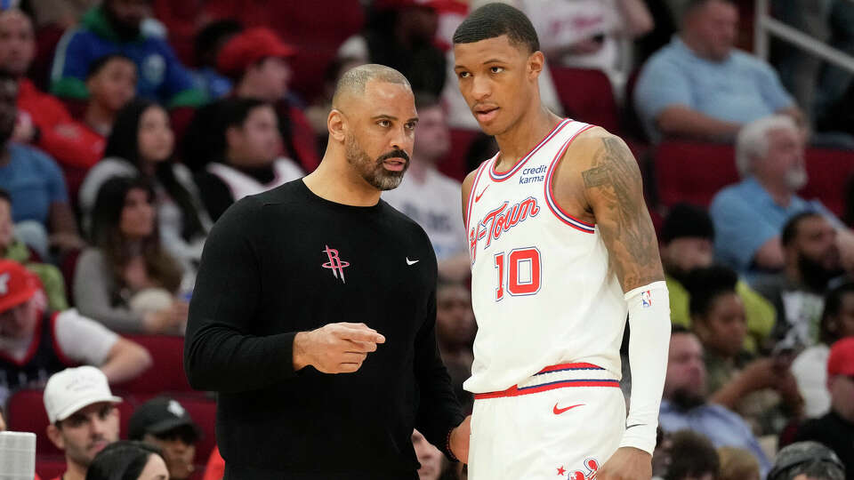 Houston Rockets head coach Ime Udoka talks with forward Jabari Smith Jr. (10) during the first half of an NBA basketball game at Toyota Center on Friday, Dec. 22, 2023, in Houston.