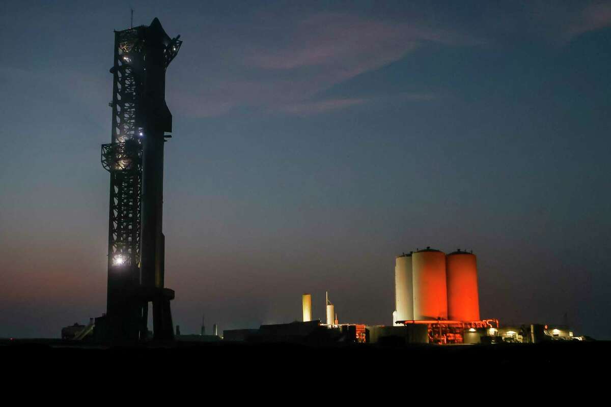 Starship 28 sits atop Booster 10 on the SpaceX Starbase launch pad at dusk at Boca Chica Beach, Brownsville, TX, on Wednesday, March 13, 2024, after receiving approval from the FAA to launch Starship flight 3.