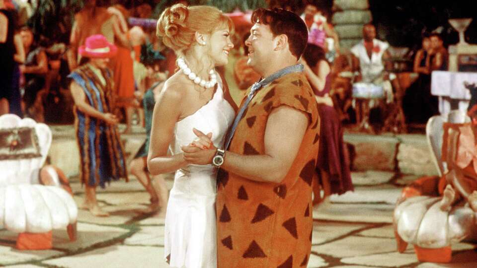 FOR IMMEDIATE RELEASE--THE FLINTSTONES IN VIVA ROCK VEGAS - Kristen Johnston, left, and Mark Addy dance in a scene from the Universal Picture's live-action comedy 'The Flintstones in Viva Rock Vegas,' opening in theaters nationwide on Friday, April 28, 2000. Addy plays Fred Flintstone, and Johnston is Wilma Slaghoople. (AP Photo/Universal Studios, Darren Michaels) HOUCHRON CAPTION (04/28/2000): Fred (Mark Addy) courts Wilma (Kristen Johnston) in ``The Flintstones in Viva Rock Vegas''.