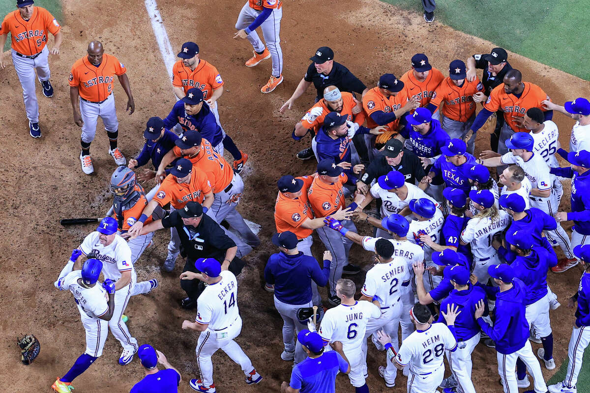 Adolis Garcia #53 of the Texas Rangers argues with Martin Maldonado #15 of the Houston Astros after being hit by a pitch by Bryan Abreu #52 of the Houston Astros causing benches to clear during the eighth inning in Game Five of the American League Championship Series at Globe Life Field on October 20, 2023 in Arlington, Texas.