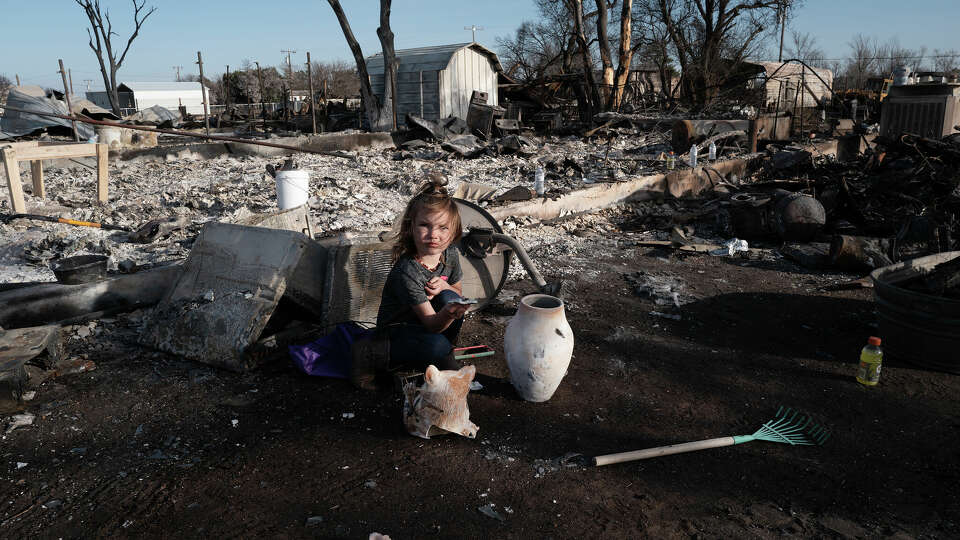 Aurora Champion does her part as her parents help a friend whose home was destroyed by the Smokehouse Creek fire on March 03, 2024 in Stinnett, Texas.