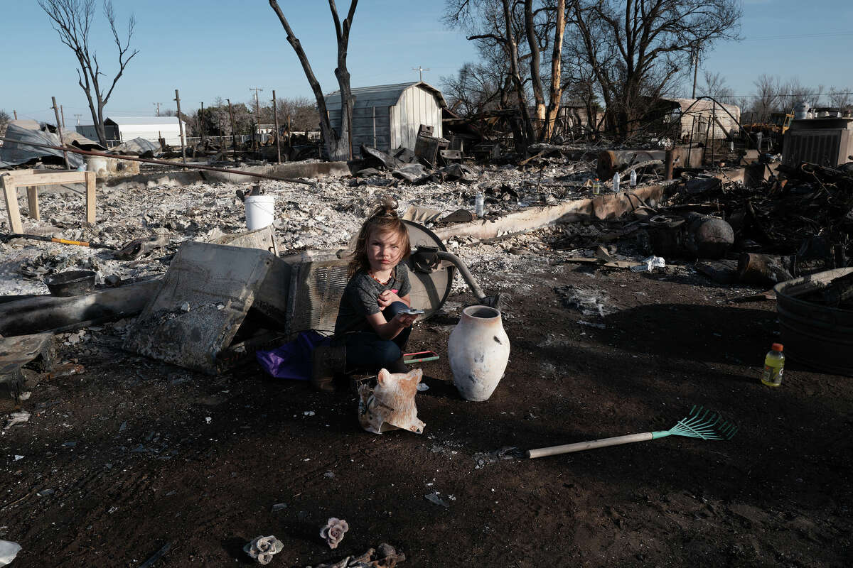 Aurora Champion does her part as her parents help a friend whose home was destroyed by the Smokehouse Creek fire on March 03, 2024 in Stinnett, Texas.