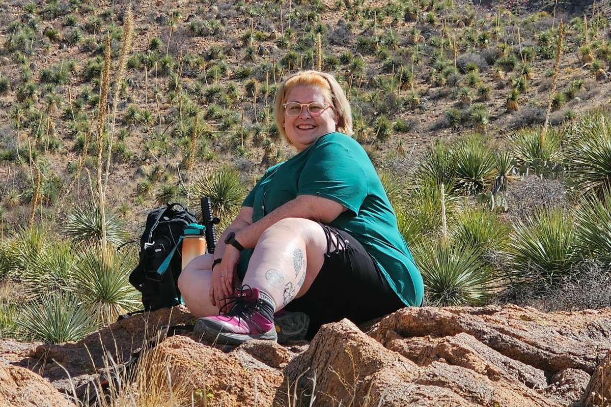 Betty Louise, 41, stops for a picture while hiking Franklin Mountains State Park in El Paso. 