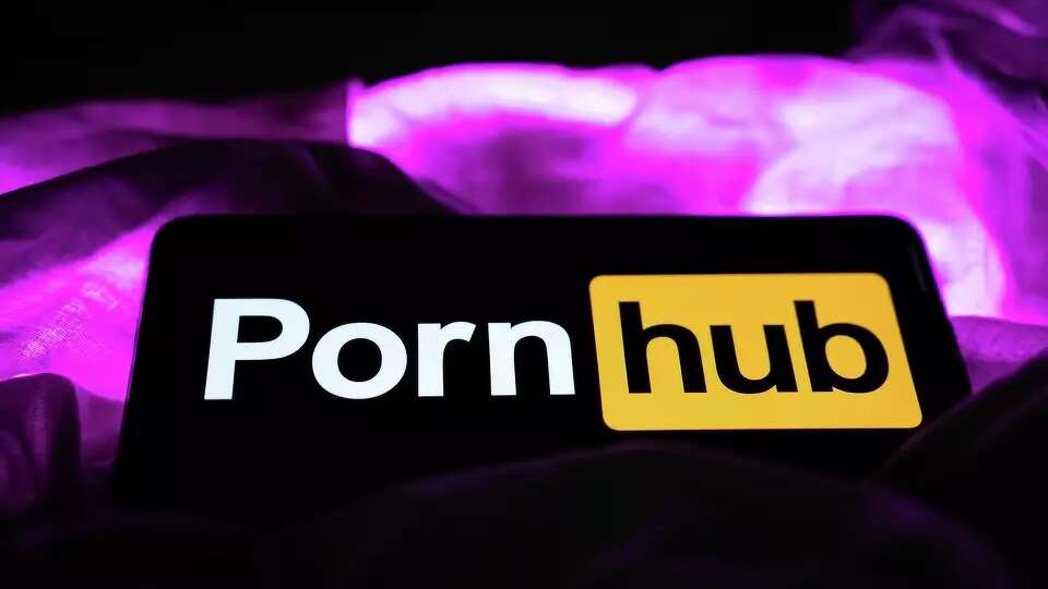 A mobile phone with the logo of Pornhub on its screen.