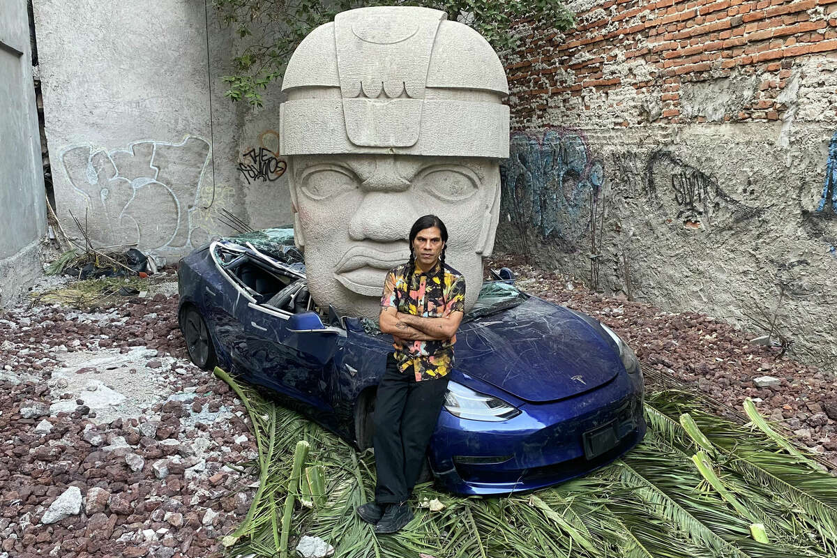 Chavis Mármol and his piece Tesla Crushed by an Olmec Head.