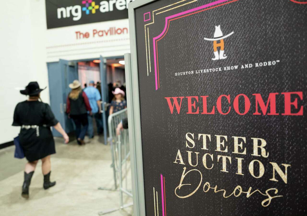 Bidders and onlookers make their way to the Houston Livestock Show and Rodeo’s steer auction at NRG Arena on Saturday, March 16, 2024 in Houston.